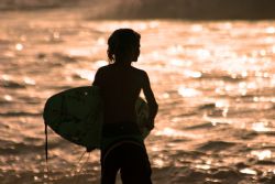 Little Surfer. This kid was out surfing Pipeline on a day... by Mathew Cook 